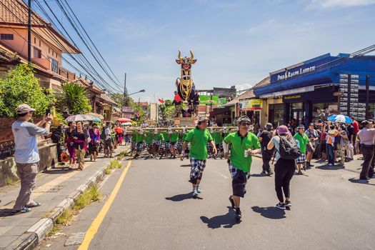 Ubud, Bali, Indonesia - April 22, 2019 : Royal cremation ceremony prepation. Balinese hindus religion procession. Bade and Lembu Black Bull symbol of transportation for the spirit to the heaven.