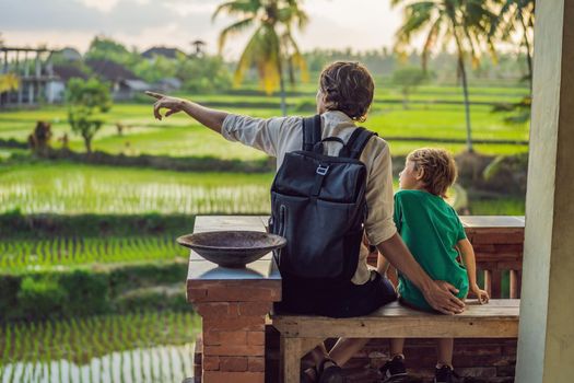 Dad and son travelers on Beautiful Rice Terraces against the background of famous volcanoes in Bali, Indonesia Traveling with children concept.