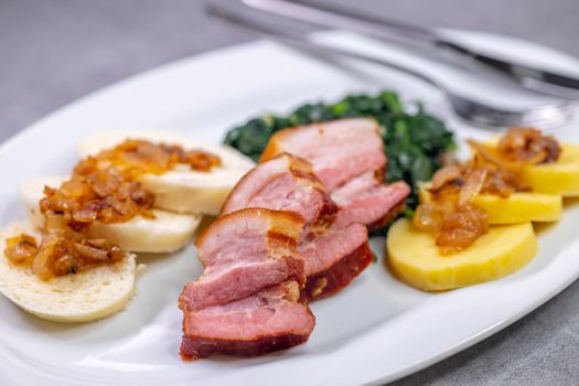 smoked flank with potato and bread dumplings and spinach