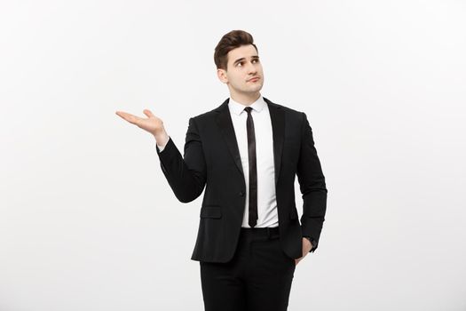 Business Concept: Attractive handsome business man shows hand on side. Copy space on white background.