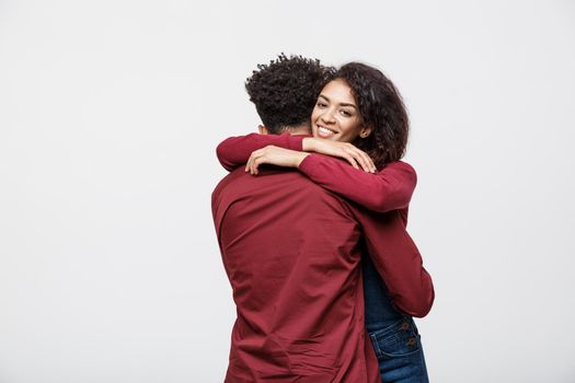 portrait of happy african american couple hug each other on white background