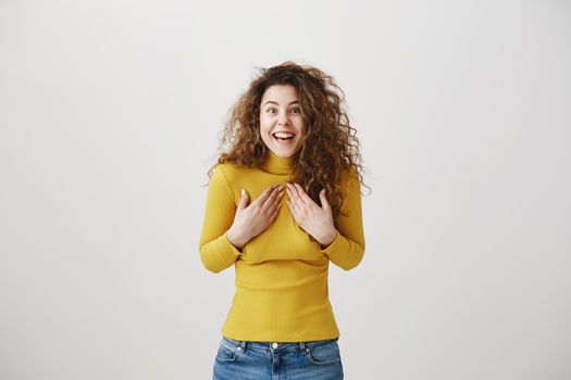 Portrait of beautiful cheerful redhead girl with curly hair smiling laughing looking at camera over white background