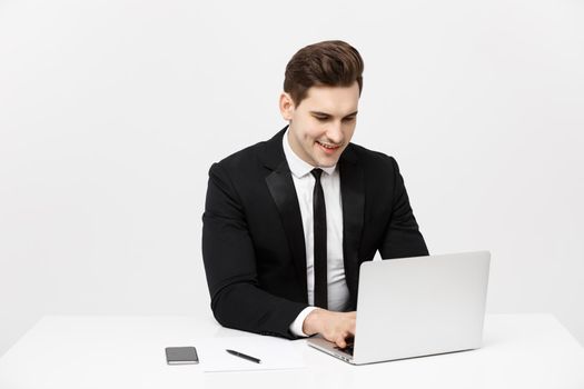 Business Concept: Portrait happy attractive businessman working on laptop at office.