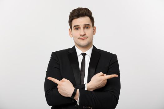 Business Concept: Portrait handsome young businessman point finger on side to empty copy space. Concept of advertisement product, isolated over white background.