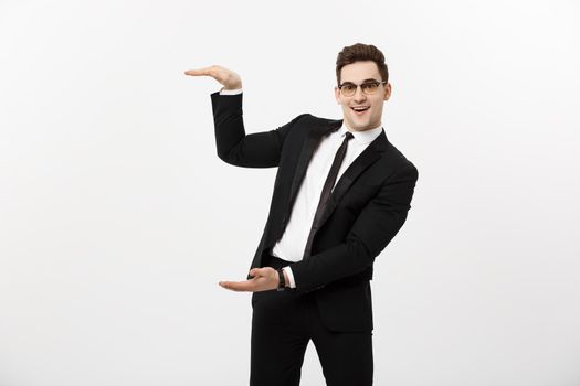 Handsome young business man happy smile, businessman showing something on the open palm, concept of advertisement product isolated over white background