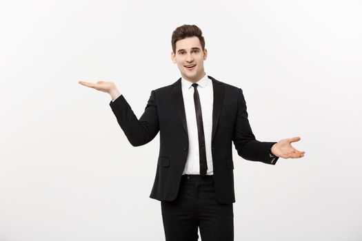Business Concept: Attractive handsome business man shows hand on side. Copy space on white background.