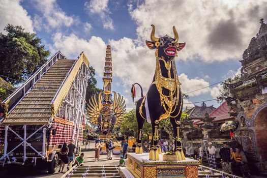 Ubud, Bali, Indonesia - April 22, 2019 : Royal cremation ceremony prepation. Balinese hindus religion procession. Bade and Lembu Black Bull symbol of transportation for the spirit to the heaven.