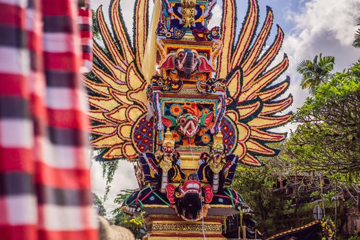 Bade cremation tower with traditional balinese sculptures of demons and flowers on central street in Ubud, Island Bali, Indonesia . Prepared for an upcoming cremation ceremony.