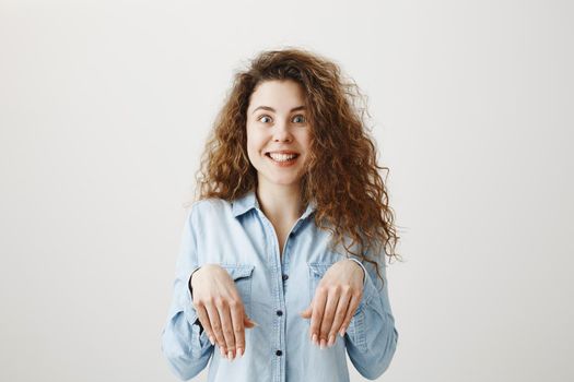 Funny girl showing bunny hands with her hands isolated on gray background.