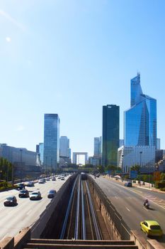 Paris, France - August 26, 2019: Day multi-lane road with skyscrapers of the La Defense.