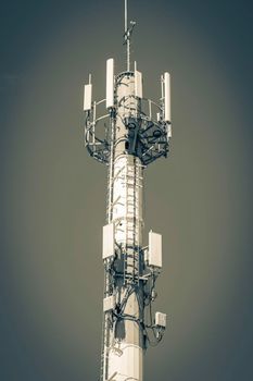 Old black and white picture Red white 5G tower with blue sky background radiation kills us in Playa del Carmen in Mexico.