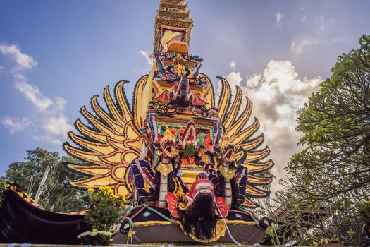 Bade cremation tower with traditional balinese sculptures of demons and flowers on central street in Ubud, Island Bali, Indonesia . Prepared for an upcoming cremation ceremony.