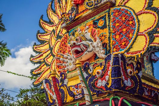 Bade cremation tower with traditional balinese sculptures of demons and flowers on central street in Ubud, Island Bali, Indonesia . Prepared for an upcoming cremation ceremony.