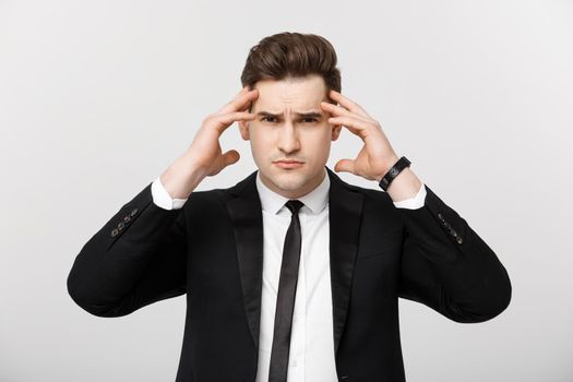 Business Concept: Young businessman with holding hands on head with headache facial expression isolated over white background.
