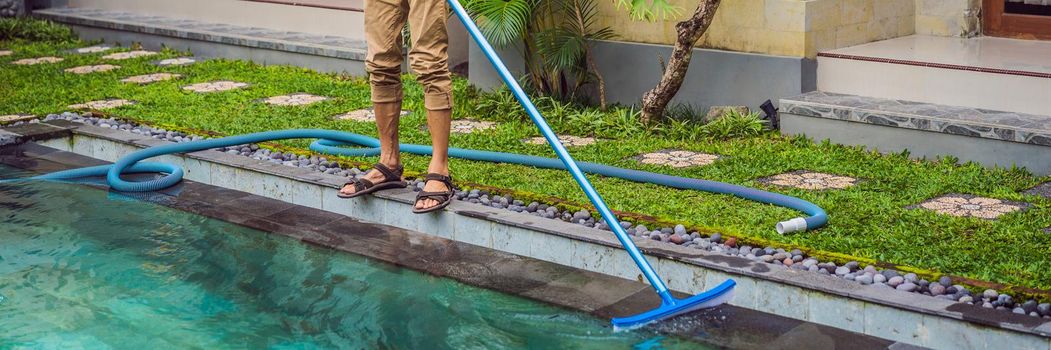 Cleaner of the swimming pool . Man in a blue shirt with cleaning equipment for swimming pools. Pool cleaning services. BANNER, LONG FORMAT