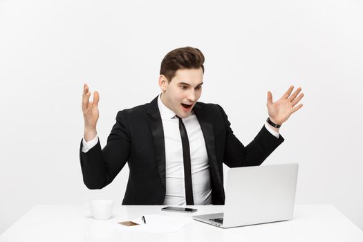 Business Concept: Portrait surprised businessman in black suit looking at camera. Front view. Isolated gray background.