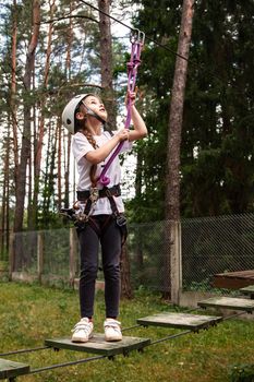 Girl on an obstacle in a rope town.