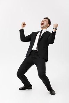 Business Concept - Handsome cheerful businessman showing hands in air over gray background