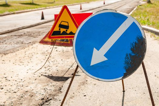 Road signs detour on the left road repair.