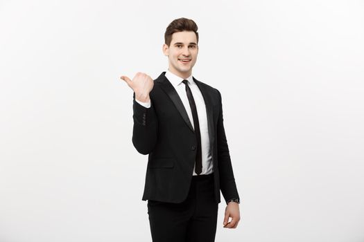 Handsome young business man happy smile point finger to empty copy space, businessman showing pointing side, concept of advertisement product, isolated over white background