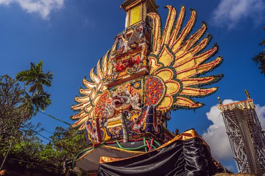 Bade cremation tower with traditional balinese sculptures of demons and flowers on central street in Ubud, Island Bali, Indonesia . Prepared for an upcoming cremation ceremony.