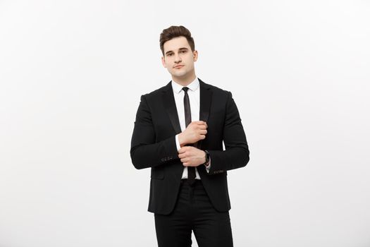 Business Concept: Handsome Man Happy Smile Young Handsome Guy in smart suit posing over Isolated Grey Background