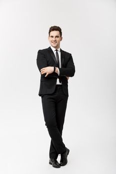 Business Concept: Handsome Man Happy Smile Young Handsome Guy in smart suit posing over Isolated Grey Background