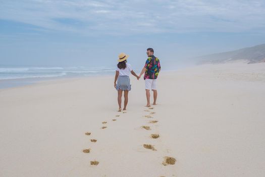 Man and Women walking at the beach De Hoop Nature reserve South Africa Western Cape, beautiful beach of south Africa with the white dunes at the de hoop nature reserve which part of the garden route