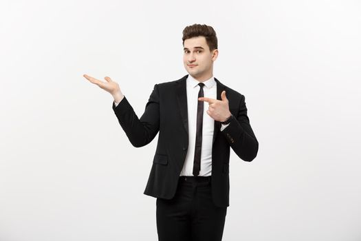 Business Concept: Attractive handsome business man shows hand on side. Copy space on white background.