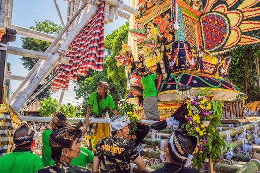 Ubud, Bali, Indonesia - April 22, 2019 : Royal cremation ceremony prepation. Balinese hindus religion procession. Bade and Lembu Black Bull symbol of transportation for the spirit to the heaven.