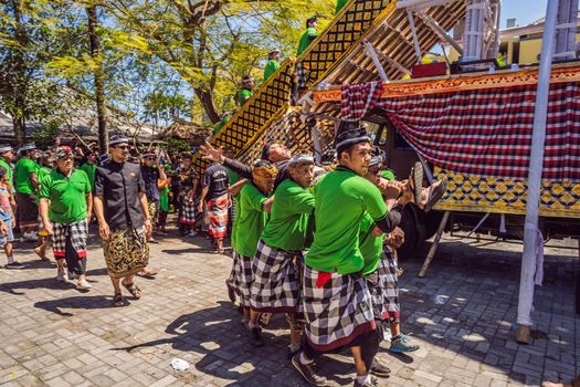 Ubud, Bali, Indonesia - April 22, 2019 : Royal cremation ceremony prepation. Balinese hindus religion procession. Bade and Lembu Black Bull symbol of transportation for the spirit to the heaven.