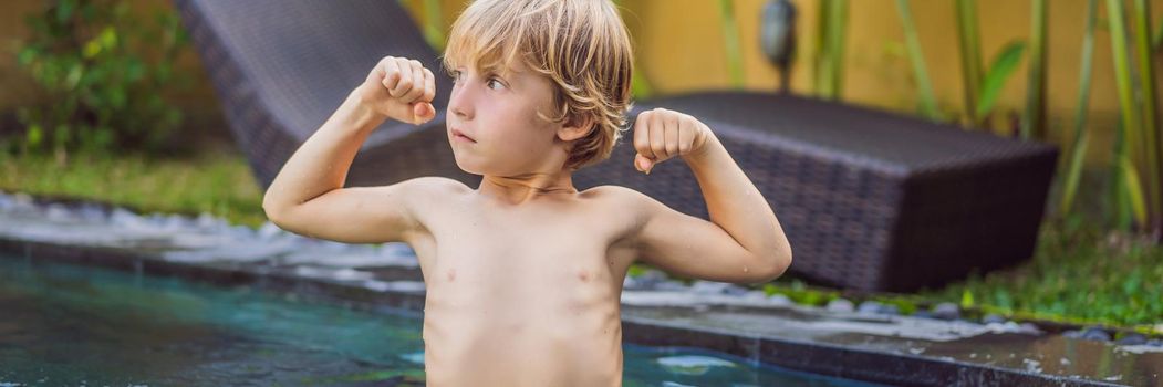 A boy shows his muscles after swimming. BANNER, LONG FORMAT