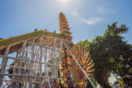 Ubud, Bali, Indonesia - April 22, 2019 : Royal cremation ceremony prepation. Balinese hindus religion procession. Bade and Lembu Black Bull symbol of transportation for the spirit to the heaven.