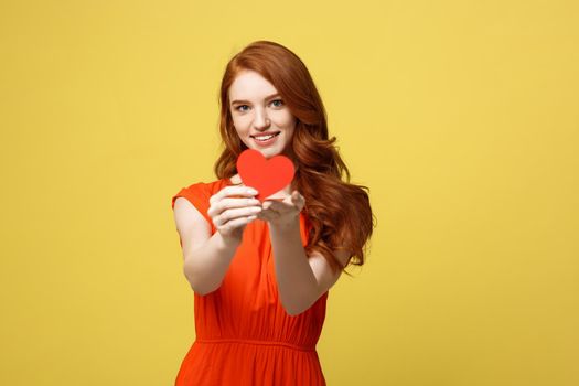 Portrait of happy romantic young caucasian girl with red paper heart-shaped postcard, romantic wishes, Valentine day celebration, love concept.