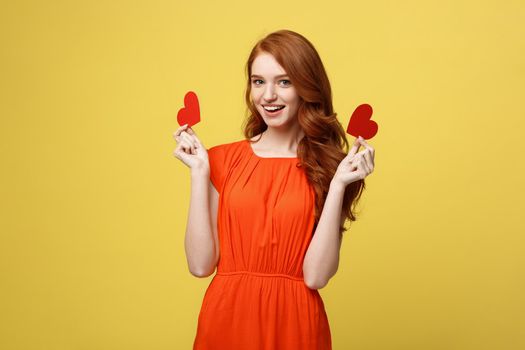 Portrait of happy romantic young caucasian girl with red paper heart-shaped postcard, romantic wishes, Valentine day celebration, love concept.