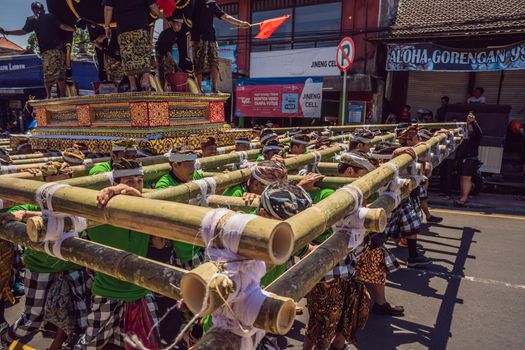 Ubud, Bali, Indonesia - April 22, 2019 : Royal cremation ceremony prepation. Balinese hindus religion procession. Bade and Lembu Black Bull symbol of transportation for the spirit to the heaven.