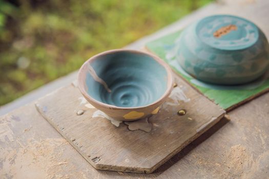 Cups on the shelves in the pottery workshop.