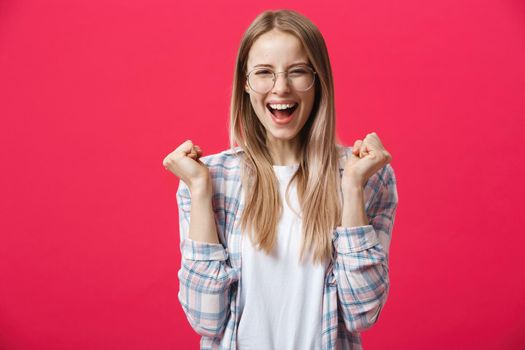 Surprised teenage student girl show shocking expression with something. Isolated on Bright Pink Background. Copy space.