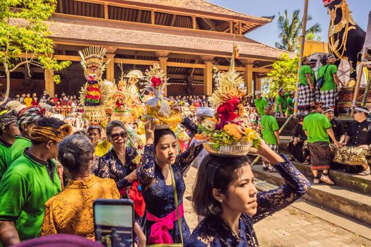 Ubud, Bali, Indonesia - April 22, 2019 : Royal cremation ceremony prepation. Balinese hindus religion procession. Bade and Lembu Black Bull symbol of transportation for the spirit to the heaven.