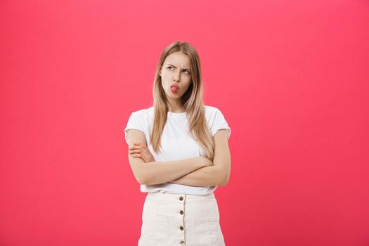 Bored woman. Boring, dull, tedious concept. Young pretty caucasian emotional woman. Human emotions, facial expression concept. Studio Isolated on trendy pink background.