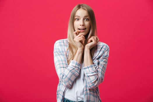 Surprised teenage student girl show shocking expression with something. Isolated on Bright Pink Background. Copy space.