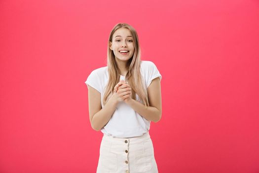 Surprised teenage student girl show shocking expression with something. Isolated on Bright Pink Background. Copy space.