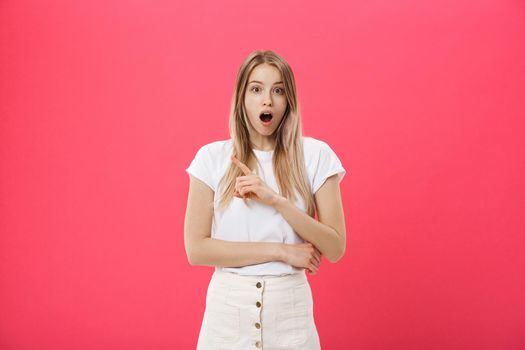 Surprised teenage student girl show shocking expression with something. Isolated on Bright Pink Background. Copy space.