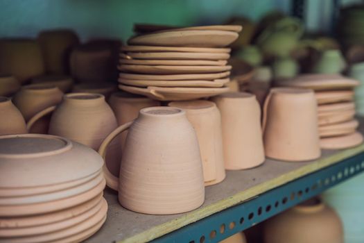 Cups on the shelves in the pottery workshop.