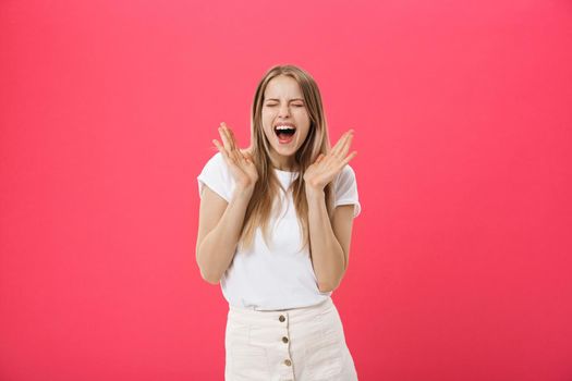 Surprised teenage student girl show shocking expression with something. Isolated on Bright Pink Background. Copy space.