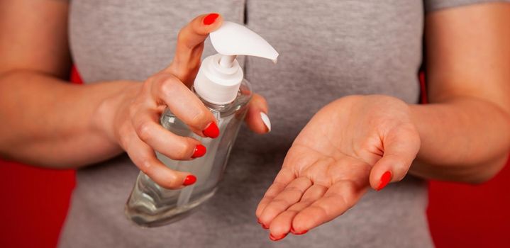 A woman uses a gel, disinfectant, antiseptic. Hand sanitizer prevents viral and plague infections, prevents the appearance of the Covid-19 virus.