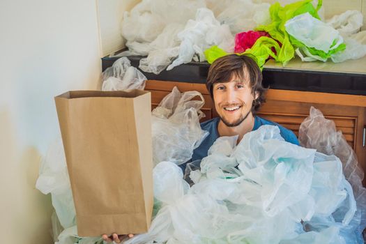 Man holding paper bag amid a pile of plastic bags. Zero waste concept. The concept of World Environment Day.
