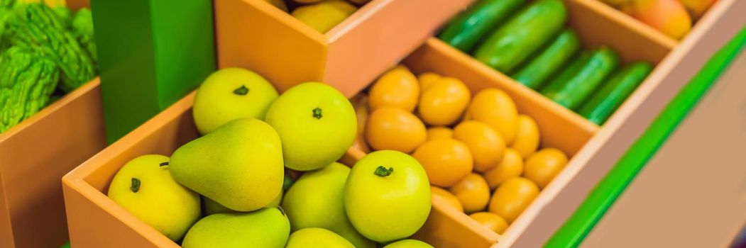 Vegetables and fruits in a toy supermarket. BANNER, LONG FORMAT