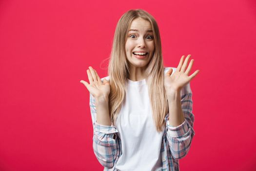 Surprised teenage student girl show shocking expression with something. Isolated on Bright Pink Background. Copy space.