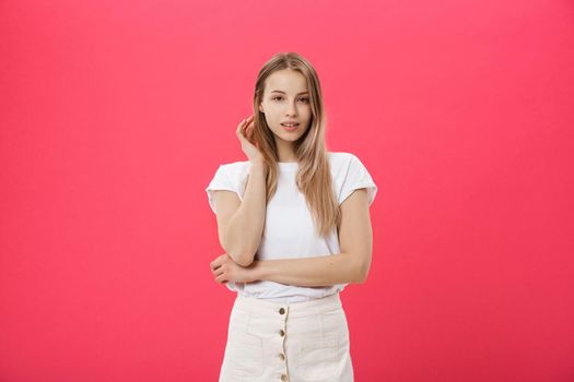 Trendy young female wearing casual clothes posing over pink background.